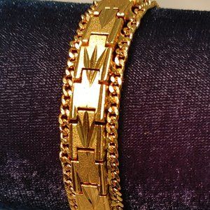 GOLD TONE BRACELET WITH SOMEWHAT SOUTHWESTERN DESIGN. no markings